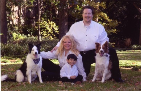 The Certain family gathers together for a family photo with their two dogs.