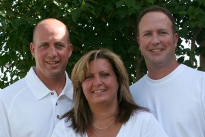 Coach Chris Melson, sister Michael Ann and brother, football coach at Denton High School, Brandon Melson